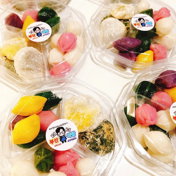 Colorful dessert items in clear plastic containers with a visible brand label.