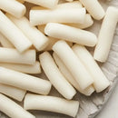 Close-up of tteokbokki tteok on a textured surface