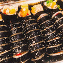 Tuna kimbap with sesame seeds on a tray