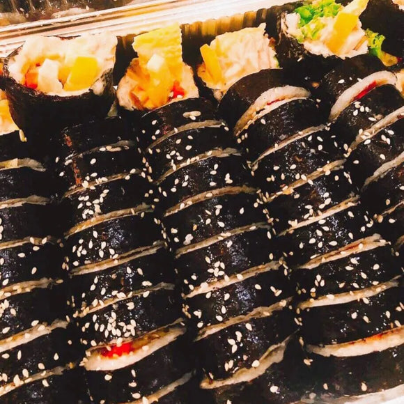 Tuna kimbap with sesame seeds on a tray