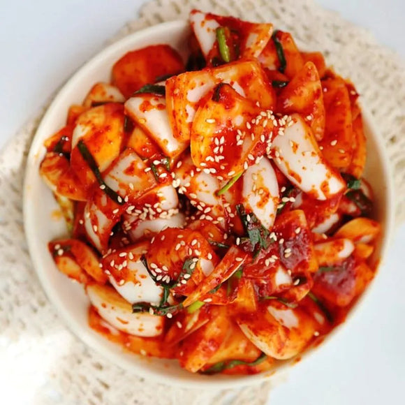 Spicy Korean onion kimchi on a white plate