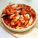 Bowl of onion kimchi on a white background