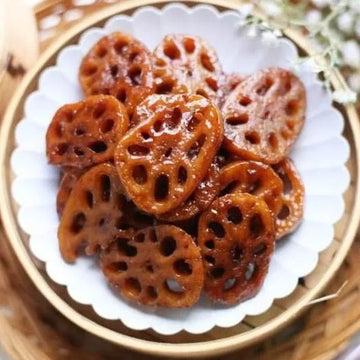 Sliced lotus roots on a white plate with a gold rim
